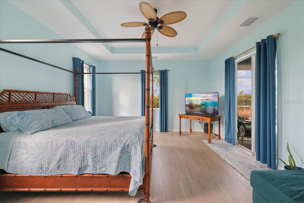 8 Abaft Place Placida, FL 33946 - Photo 15 of 45 a bedroom with a bed and a chandelier