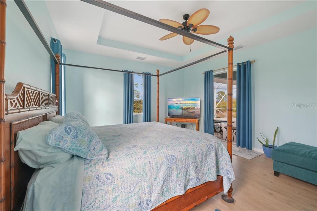 8 Abaft Place Placida, FL 33946 - Photo 16 of 45 a bedroom with a bed chandelier and a window