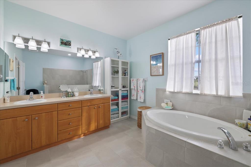 8 Abaft Place Placida, FL 33946 - Photo 17 of 45 a bathroom with a tub a sink and a large mirror