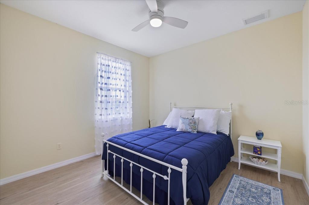 8 Abaft Place Placida, FL 33946 - Photo 22 of 45 a bed sitting in a bedroom next to a window with a chandelier