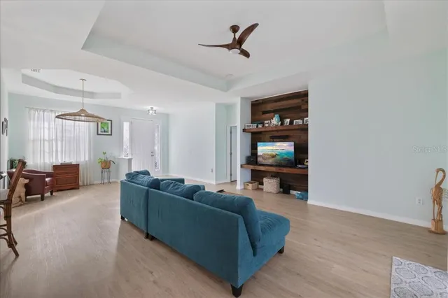 a living room with furniture and kitchen view