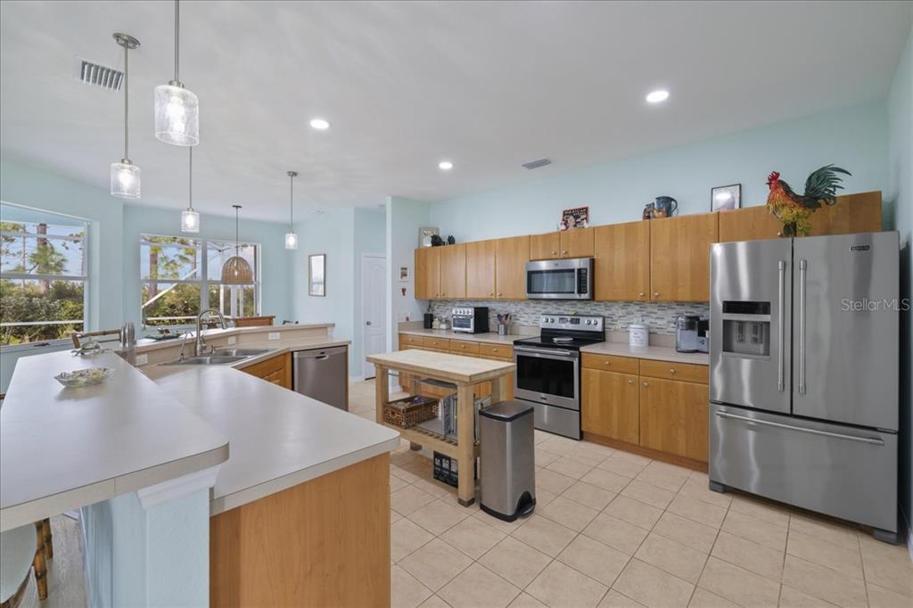 8 Abaft Place Placida, FL 33946 - Photo 10 of 45 a kitchen with a sink a refrigerator and chairs