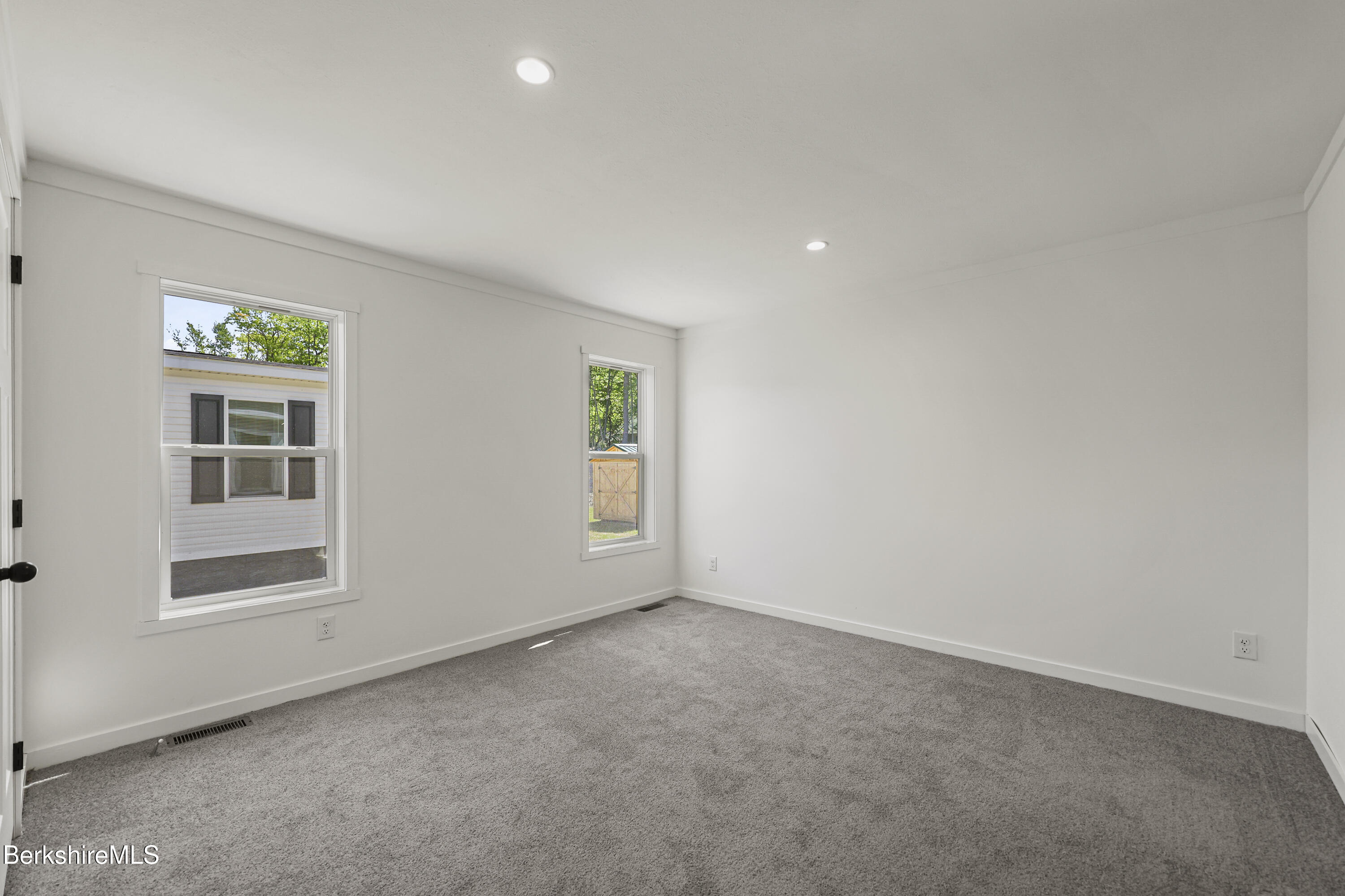 395 Cheshire Road, Unit 112 Pittsfield, MA 01201 - Photo 20 of 32 an empty room with windows