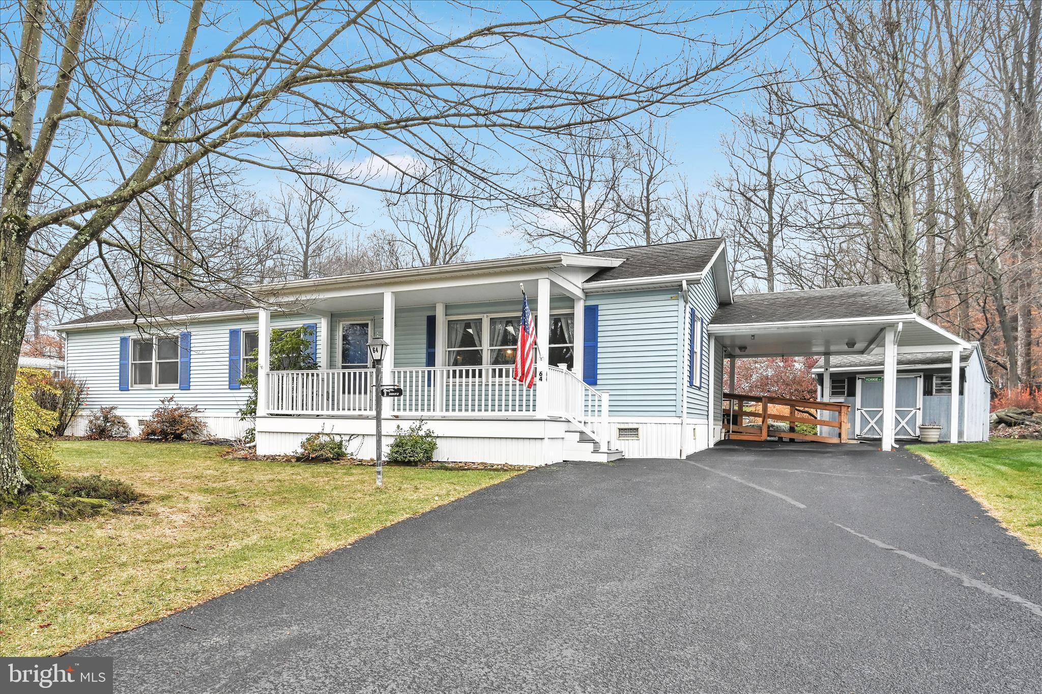 a view of a house with a large windows and a large tree