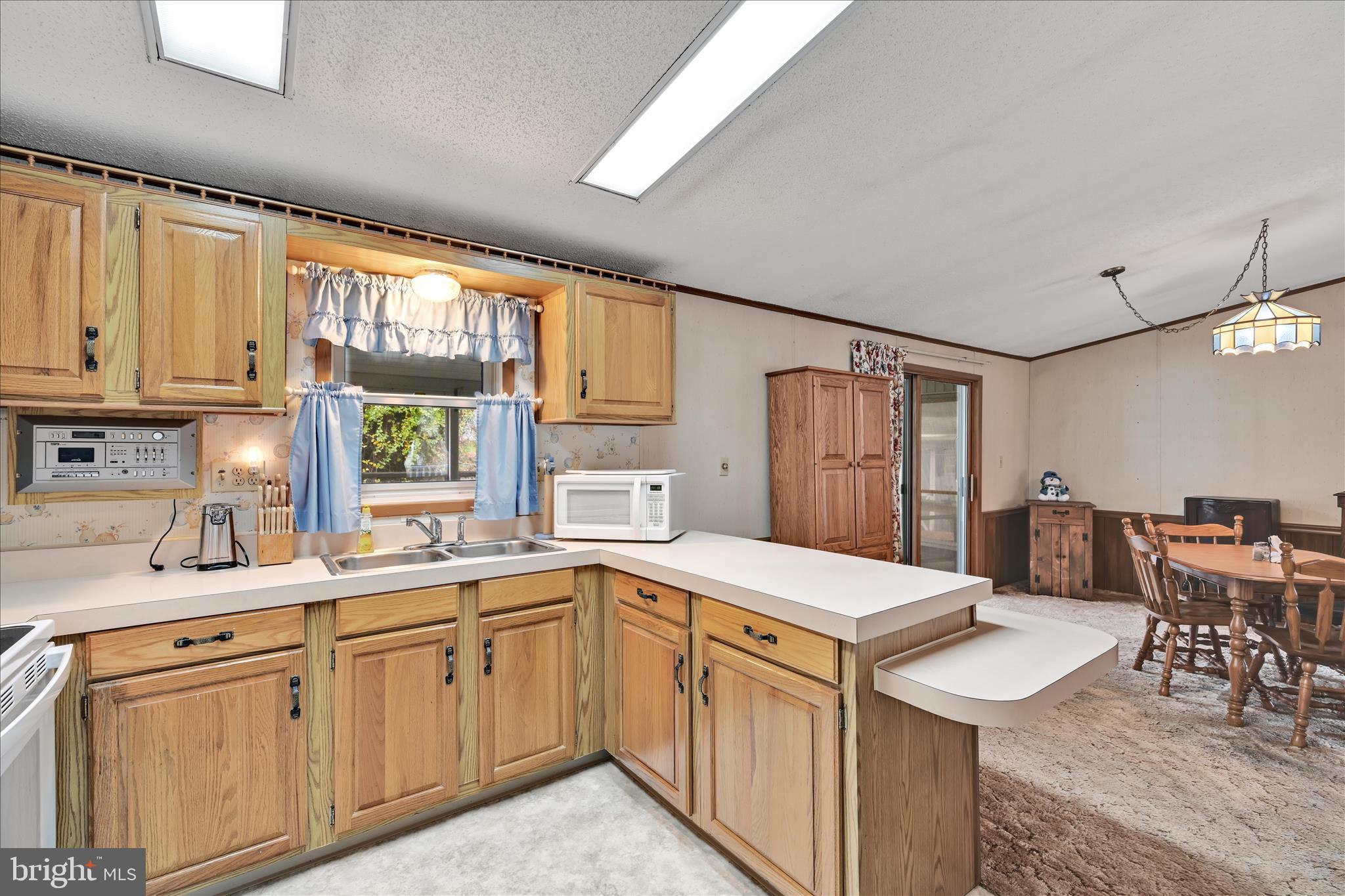 64 Maple Avenue Manheim, PA 17545 - Photo 14 of 36 a kitchen with a sink window and cabinets