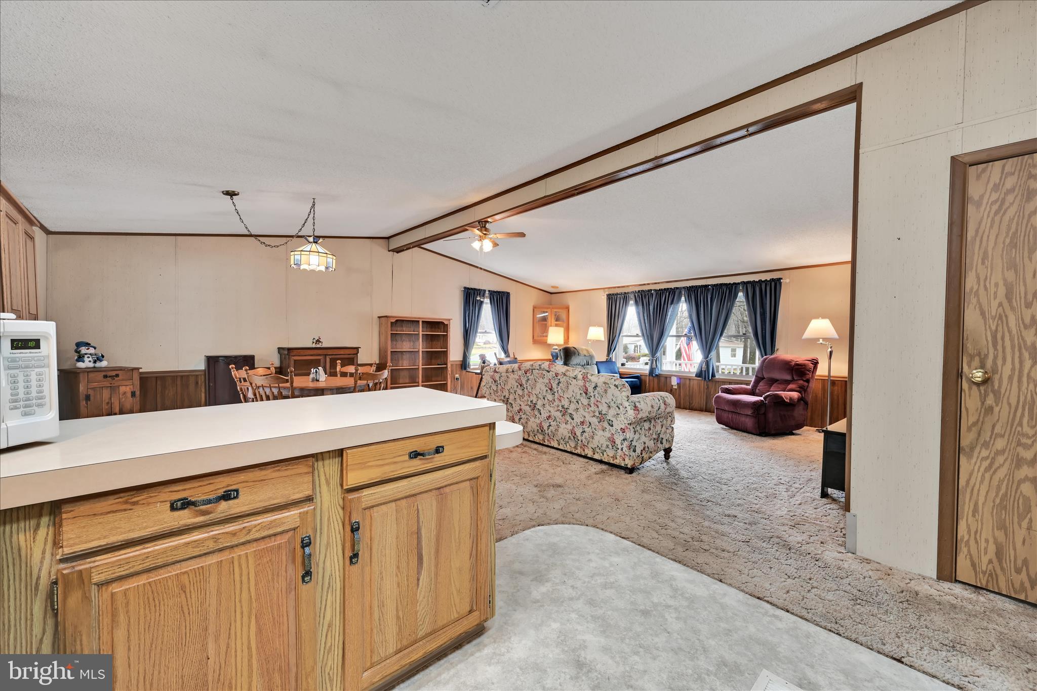 64 Maple Avenue Manheim, PA 17545 - Photo 16 of 36 a living room with furniture a chandelier and a flat screen tv