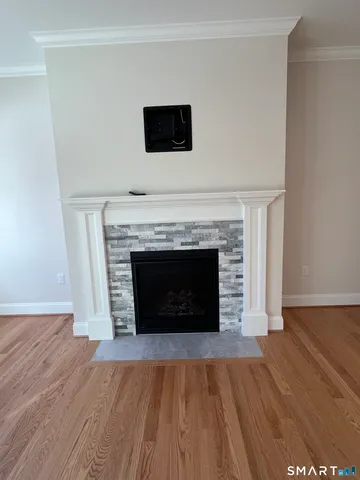 a living room with a fireplace and a wooden floor