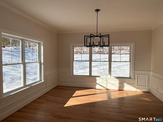 a view of a room with wooden floor and windows