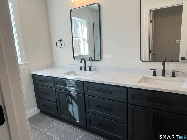 a bathroom with a double vanity sink and mirror