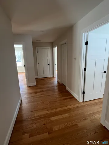 a view of a hallway with wooden floor
