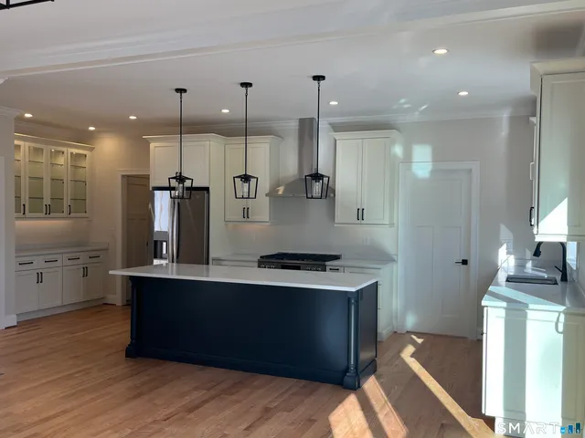 a large kitchen with stainless steel appliances kitchen island a large island in the center