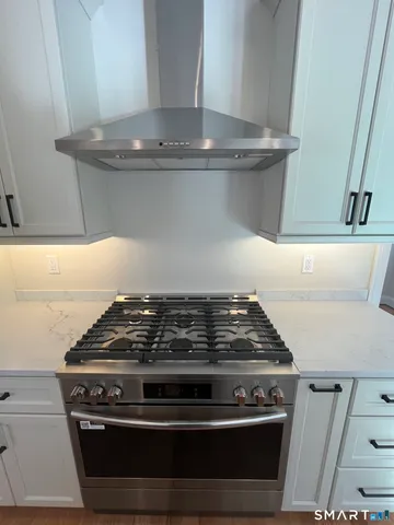 a stove sitting inside of a kitchen