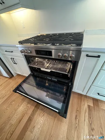 a view of a stove top oven and sitting area