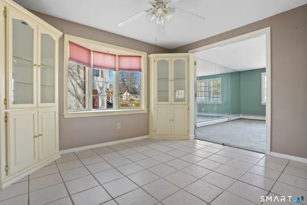 a kitchen with cabinets stainless steel appliances and a window