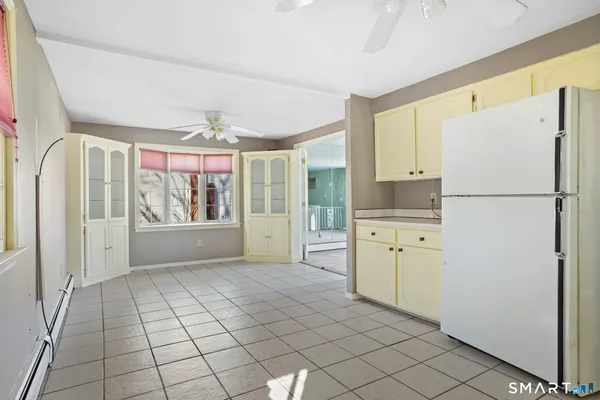 an empty room with windows and closet