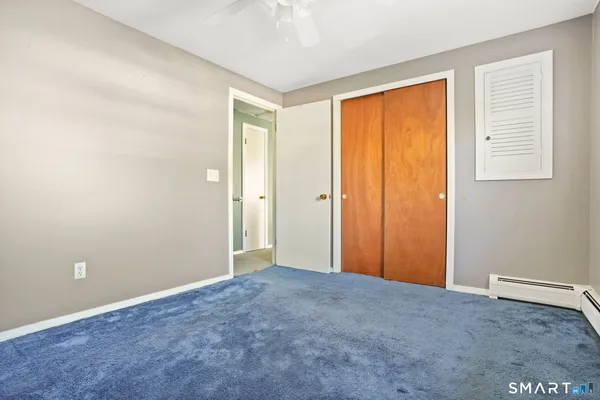 a view of an empty room with a fireplace and a window