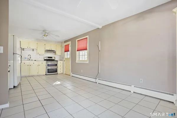 a kitchen with a cabinets and a refrigerator
