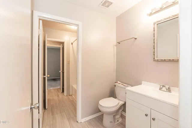 a white toilet sitting next to a bathroom sink