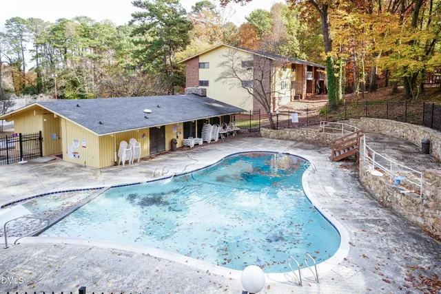 a view of a white house with a yard patio and fire pit
