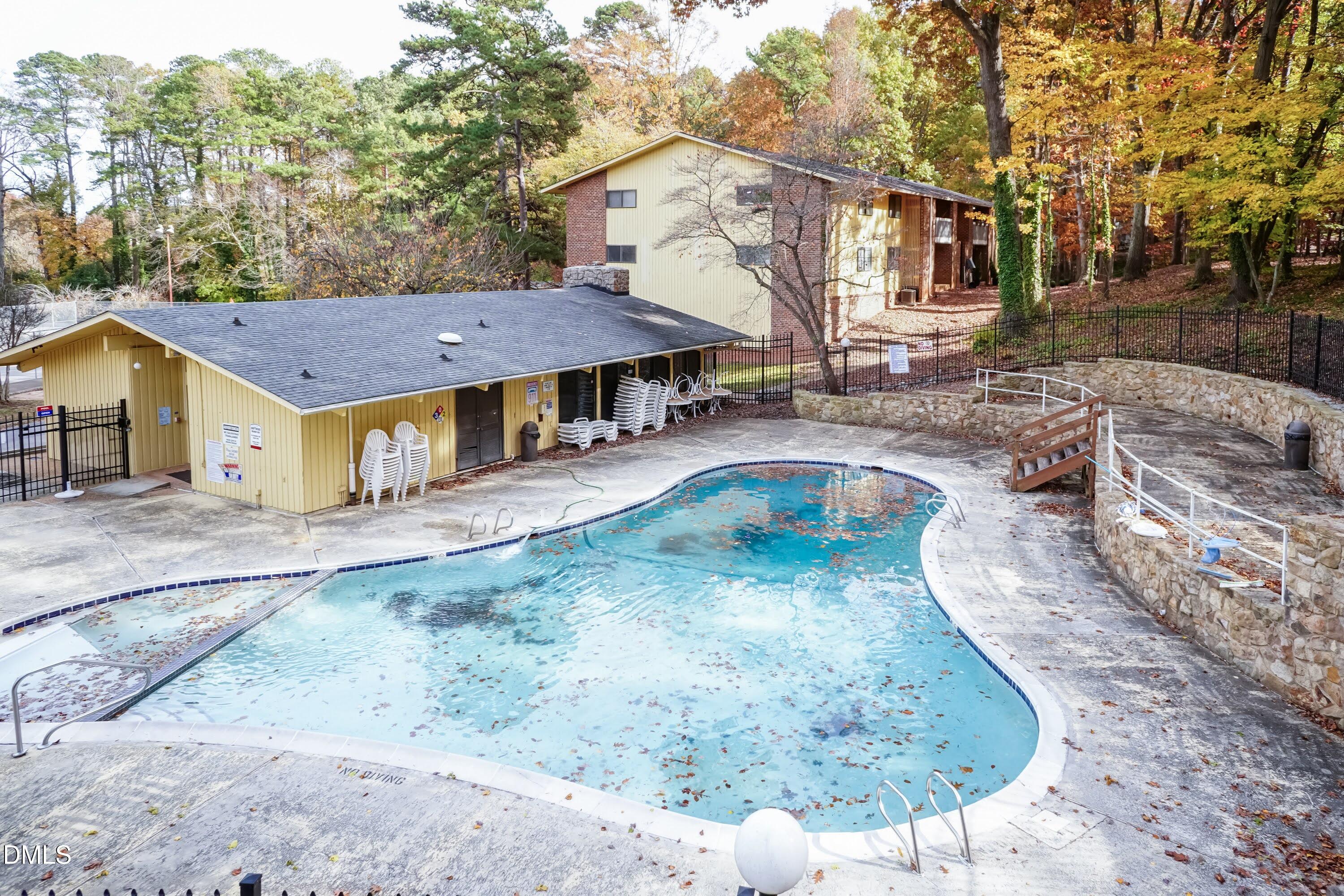 1231 Schaub Drive Raleigh, NC 27606 - Photo 22 of 23 a view of a white house with a yard patio and fire pit