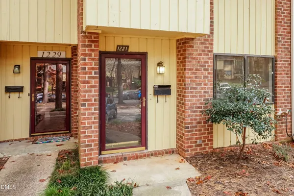 a view of a brick building with a door and a window