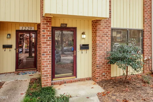 a view of a brick building with a door and a window