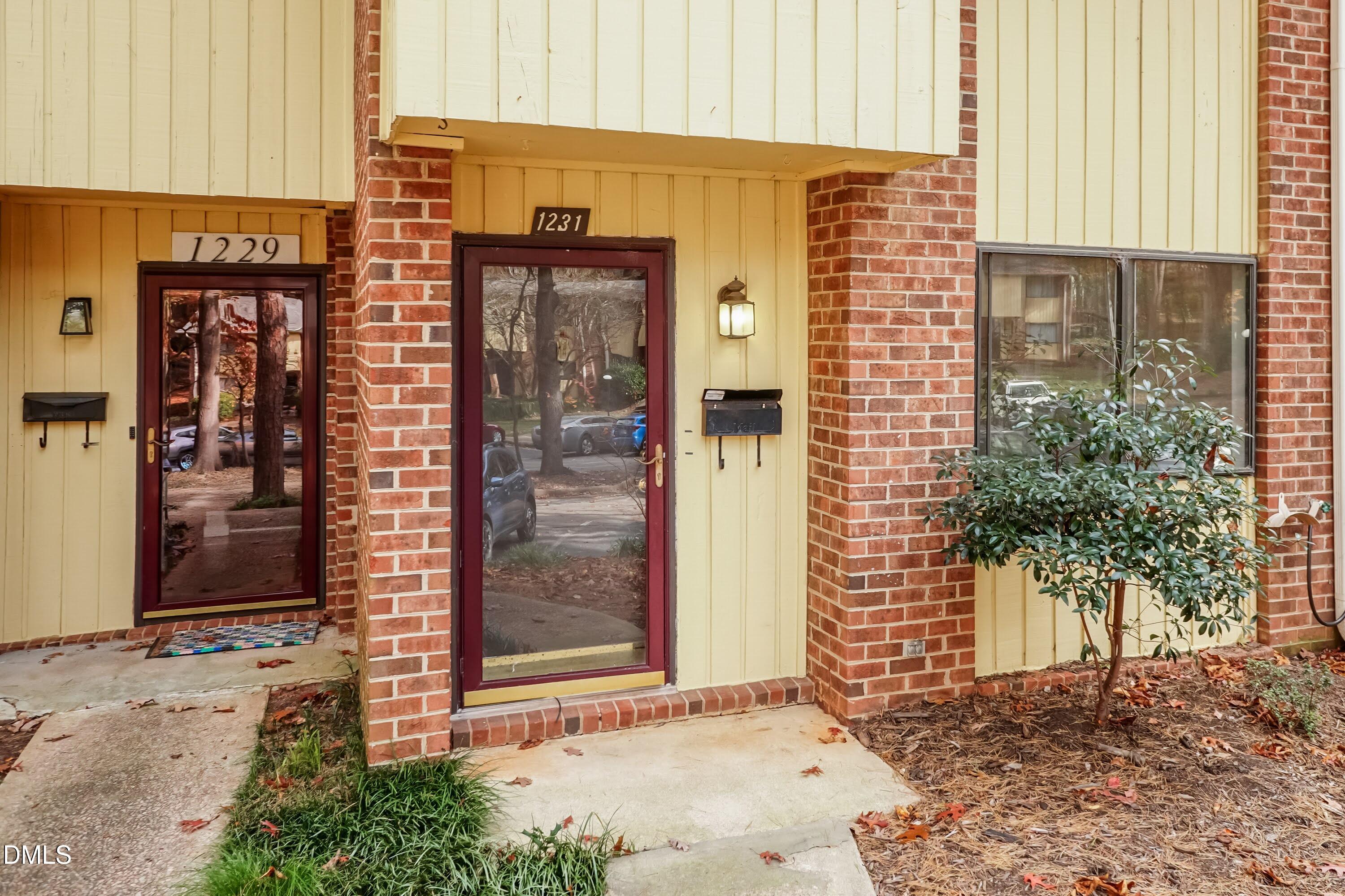 1231 Schaub Drive Raleigh, NC 27606 - Photo 3 of 23 a view of a brick building with a door and a window
