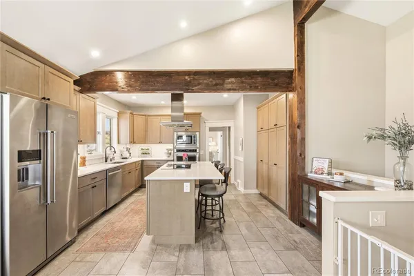 a kitchen with granite countertop a sink appliances cabinets and furniture