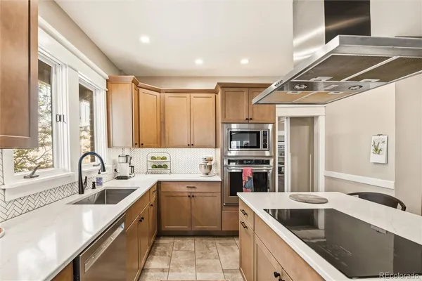 a kitchen with a sink cabinets and stainless steel appliances