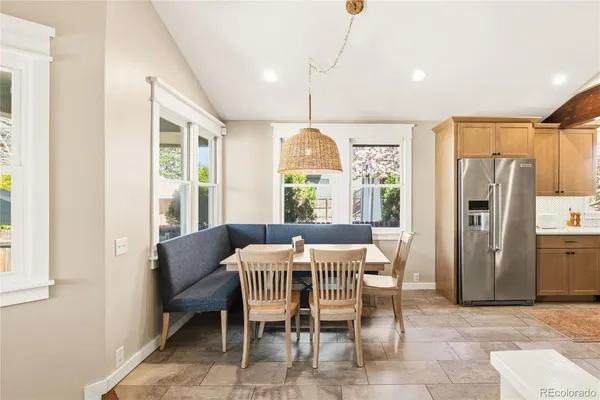 a dining room with furniture a chandelier and window