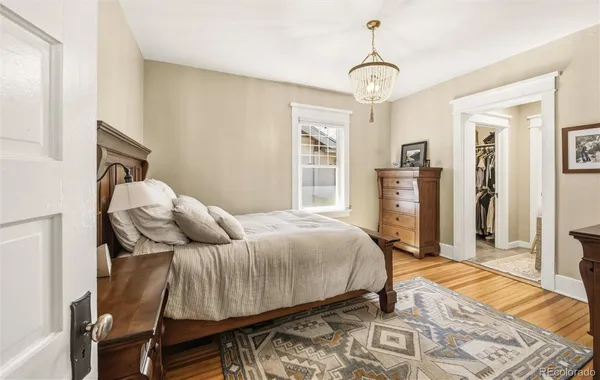 a bed room with a bed and a chandelier