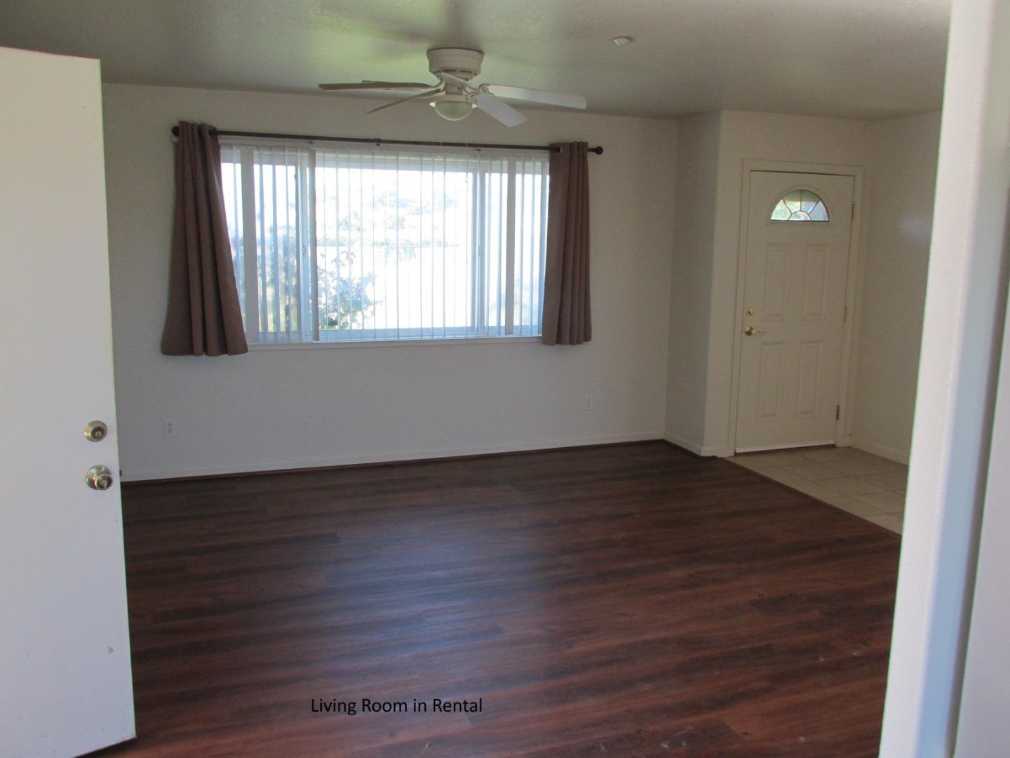 38780 Dinosaur Point Road Hollister, CA 95023 - Photo 19 of 34 an empty room with wooden floor and windows