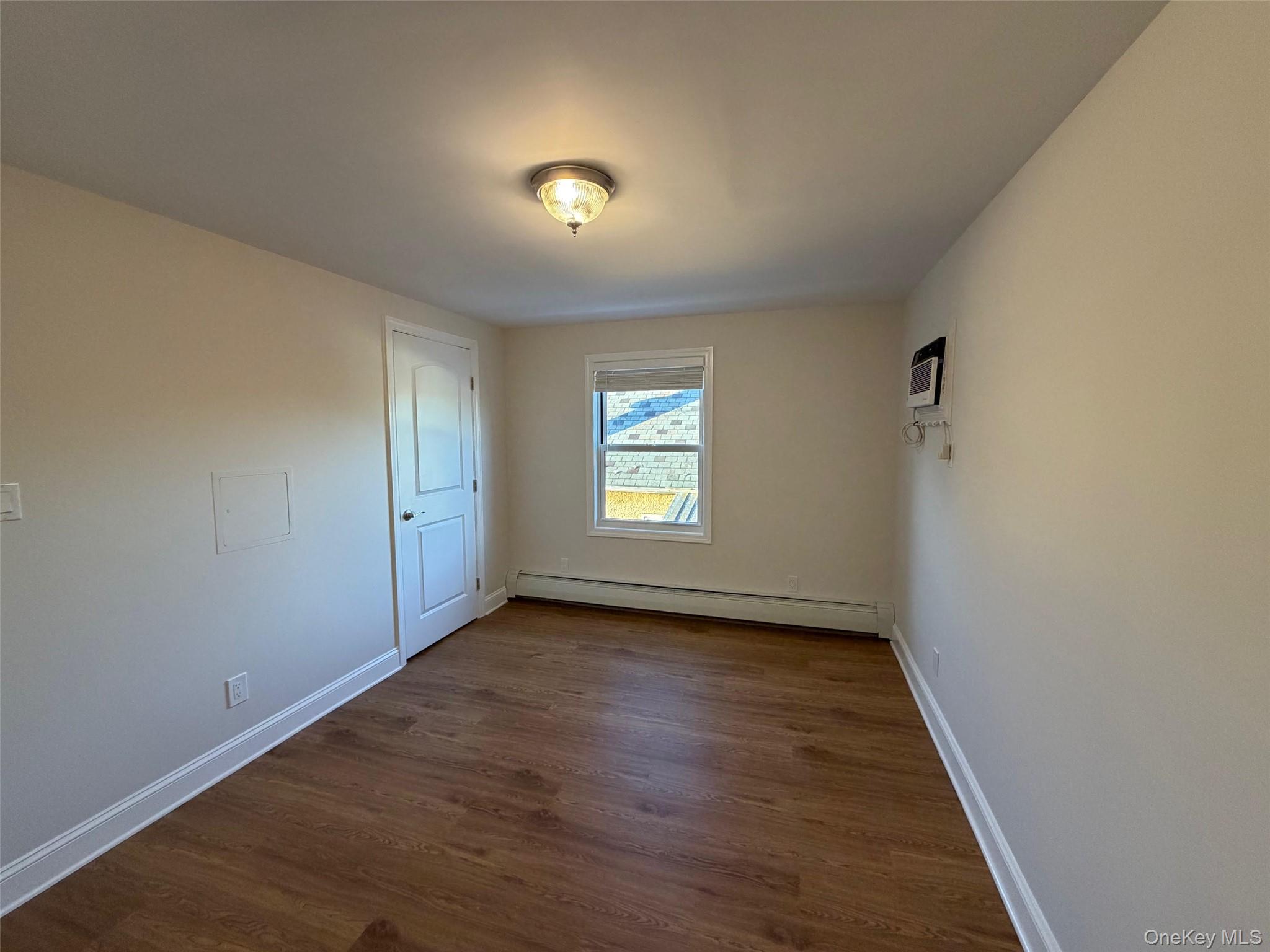 6 Marwood Road South Port Washington, NY 11050 - Photo 11 of 13 an empty room with wooden floor and windows