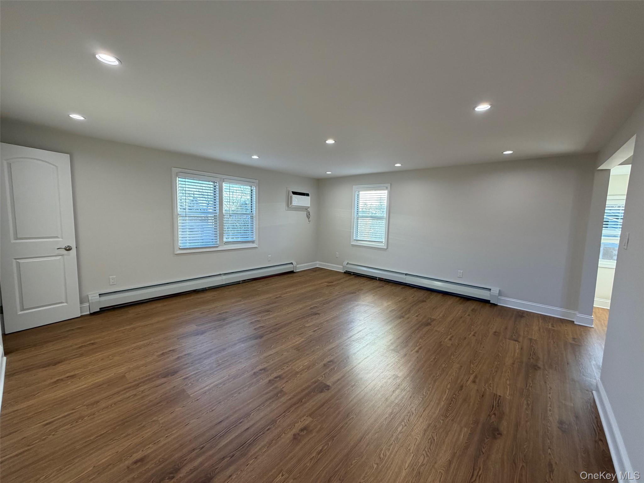 6 Marwood Road South Port Washington, NY 11050 - Photo 6 of 13 an empty room with wooden floor and windows