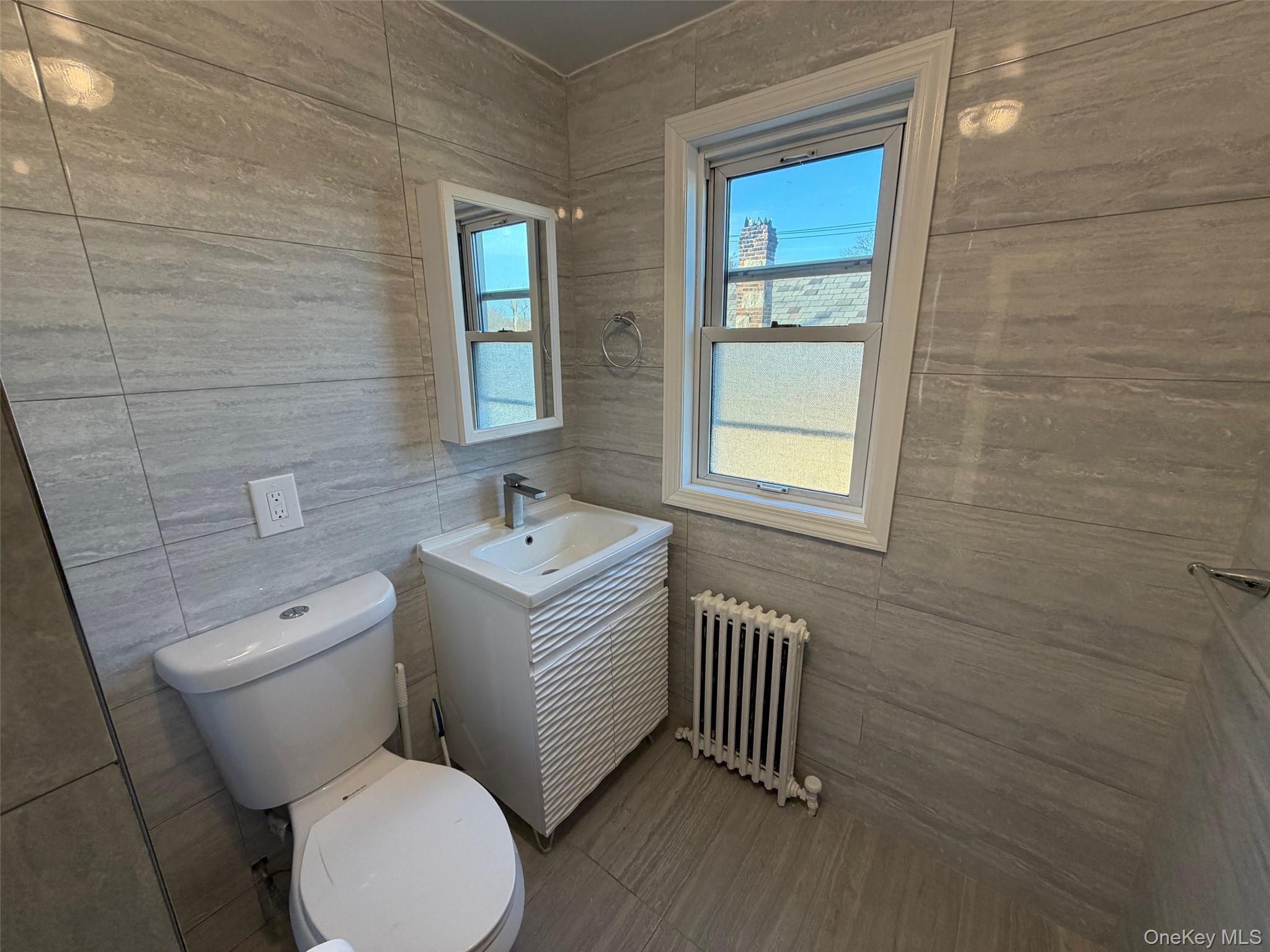 6 Marwood Road South Port Washington, NY 11050 - Photo 9 of 13 a bathroom with a toilet sink and mirror