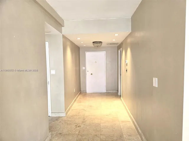 a view of hallway with a bathroom