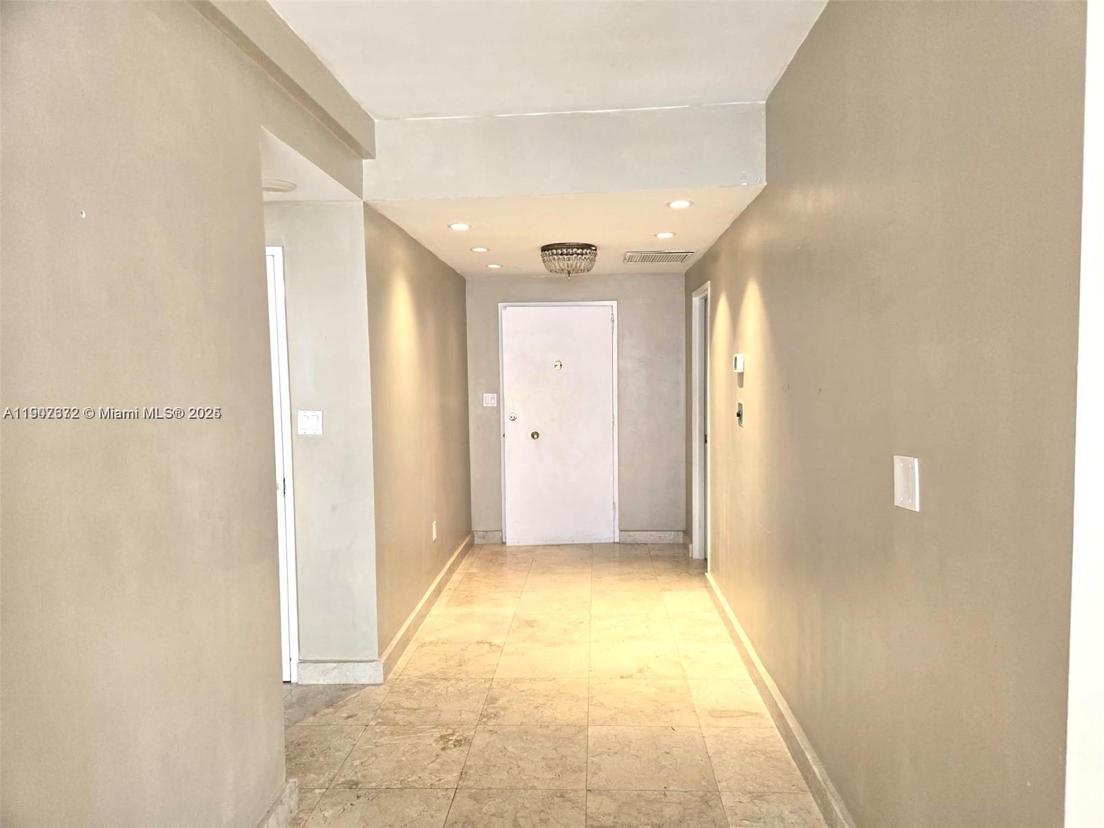5255 Collins Avenue, Unit 7B Miami Beach, FL 33140 - Photo 6 of 12 a view of hallway with a bathroom