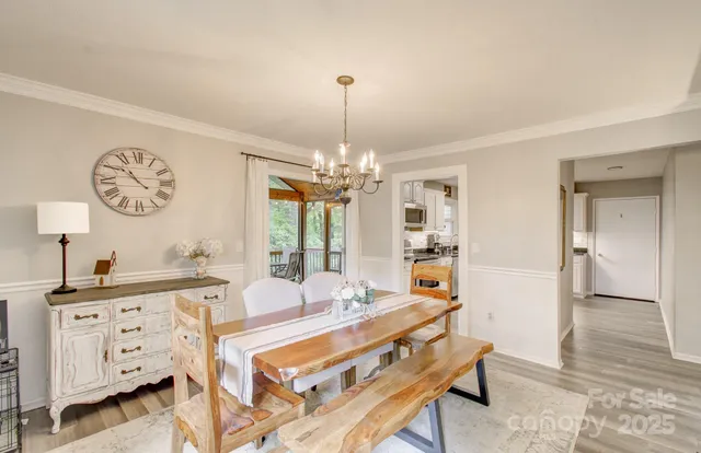 a living room with furniture a table and a large window
