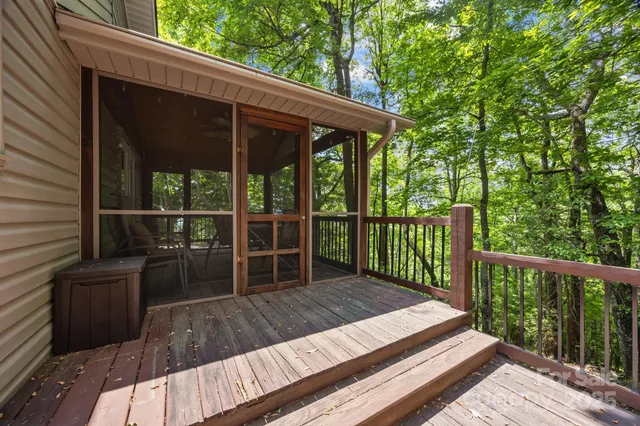 a backyard of a house with table and chairs with wooden fence