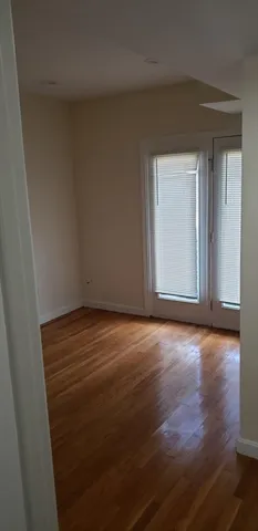 an empty room with wooden floor