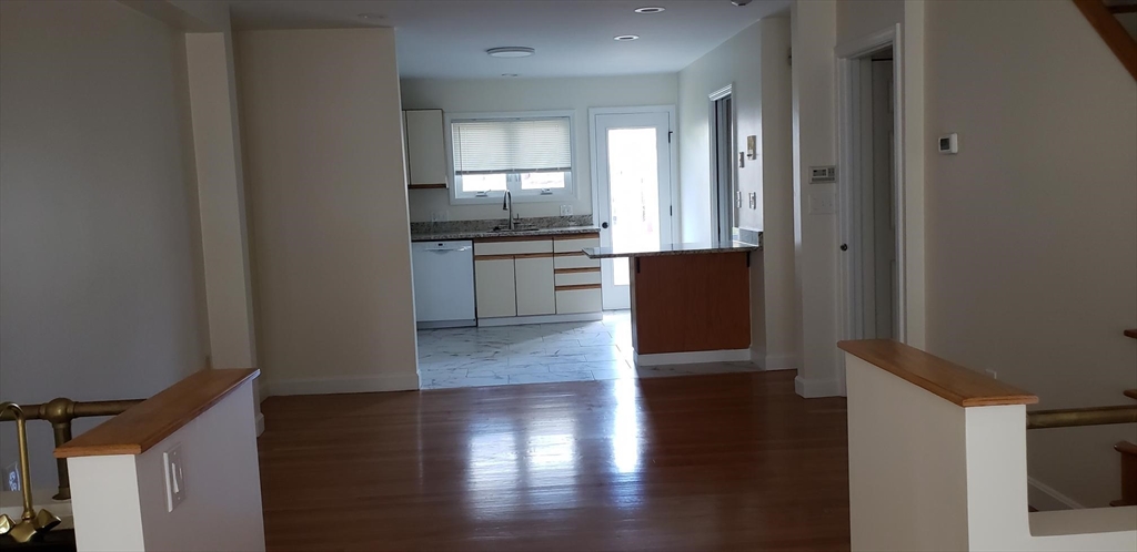 8 Rollins Court, Unit 8 Cambridge, MA 02139 - Photo 6 of 9 a kitchen with a refrigerator and white cabinets