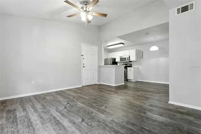 a view of a kitchen with a sink and refrigerator