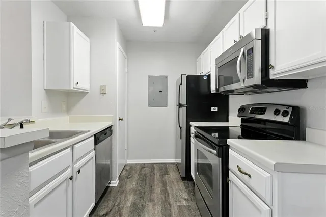 a kitchen with stainless steel appliances a stove microwave and a refrigerator