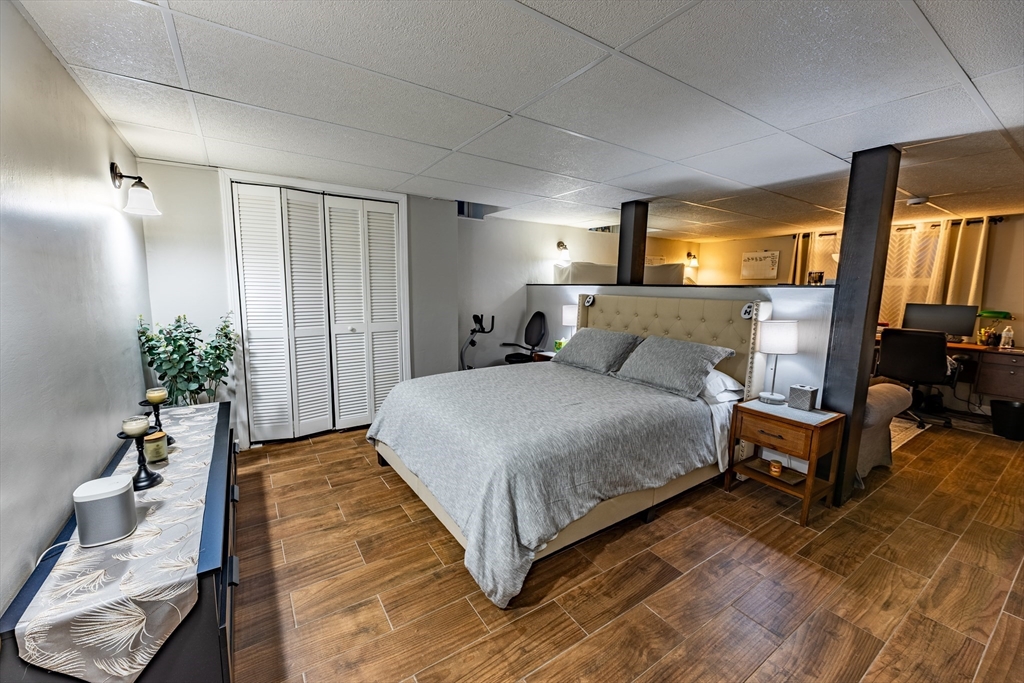 32 Farmington Street, Unit 1 Worcester, MA 01603 - Photo 12 of 25 a bedroom with a bed and a potted plant