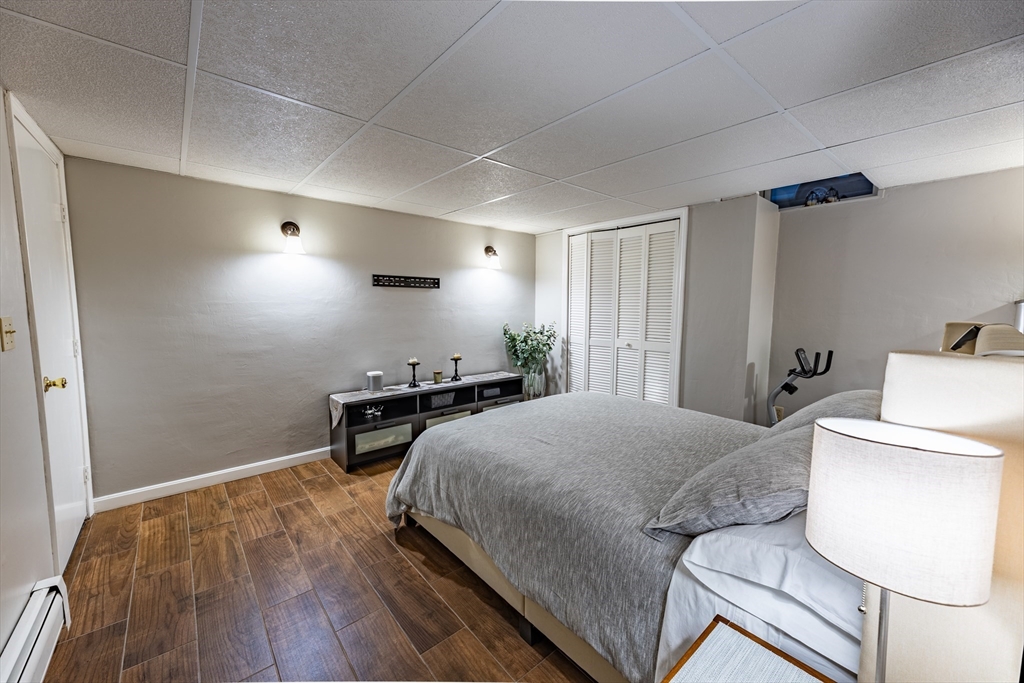 32 Farmington Street, Unit 1 Worcester, MA 01603 - Photo 13 of 25 a bedroom with a bed and a table in it