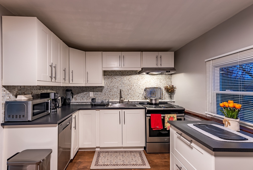 32 Farmington Street, Unit 1 Worcester, MA 01603 - Photo 16 of 25 a kitchen with stainless steel appliances granite countertop a stove and cabinets
