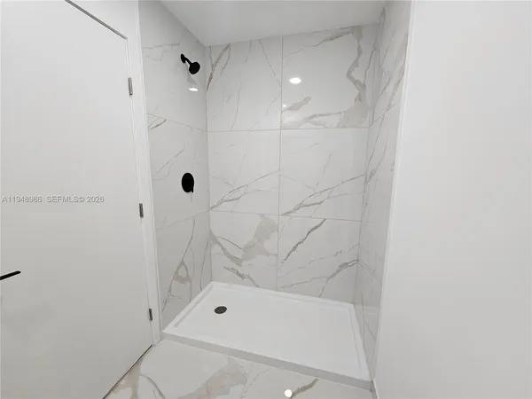 a bathroom with a granite countertop toilet a sink and a mirror