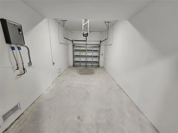 a view of room with stairs and mirrors