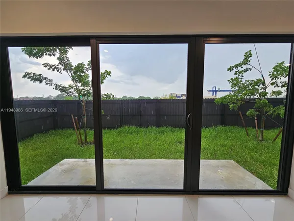 a view of a back yard from a room
