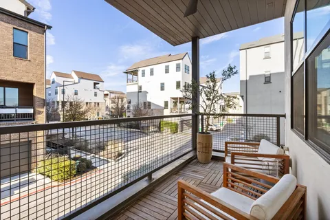 a view of balcony with wooden floor